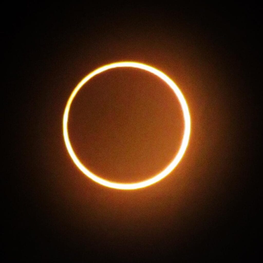 An annular solar eclipse shows a bright ring of sunlight around the moon